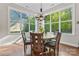 Bright breakfast nook featuring a wooden table, chairs, and large windows overlooking the lush green yard at 4012 Brandywine Ter, Lancaster, SC 29720