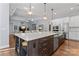 Spacious kitchen island with seating, elegant pendant lighting, and seamless flow to the living area at 4012 Brandywine Ter, Lancaster, SC 29720