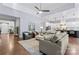 Inviting living room with plush sofas, tray ceiling, ceiling fan and seamless flow into the bright, modern kitchen at 4012 Brandywine Ter, Lancaster, SC 29720