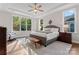 A spacious main bedroom with tray ceiling, sitting area, and views of the natural landscape at 4012 Brandywine Ter, Lancaster, SC 29720