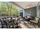 This covered patio features an outdoor kitchen, ample seating, ceiling fan, and wooded views at 4012 Brandywine Ter, Lancaster, SC 29720