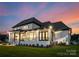 Spacious backyard featuring a covered patio and lush lawn, perfect for outdoor entertaining and relaxation at 405 Sugar Maple Ln # 41, Weddington, NC 28104