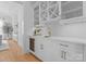 Stylish bar area with white cabinets, gold hardware, wine fridge, and convenient sink at 405 Sugar Maple Ln # 41, Weddington, NC 28104
