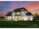 Elegant two-story home with a well-kept lawn and sophisticated design, beautifully lit in the evening at 405 Sugar Maple Ln # 41, Weddington, NC 28104