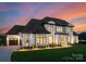 Attractive home with a manicured lawn, a two-car garage, and subtle landscaping, captured at dusk at 405 Sugar Maple Ln # 41, Weddington, NC 28104
