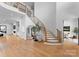 Grand foyer features a curved staircase with modern railings and hardwood floors, creating an inviting entrance at 405 Sugar Maple Ln # 41, Weddington, NC 28104