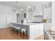 Gourmet kitchen featuring a large center island with stool seating and custom white cabinetry at 405 Sugar Maple Ln # 41, Weddington, NC 28104