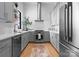 Modern kitchen featuring stainless steel appliances, gray cabinetry, and a white subway tile backsplash at 405 Sugar Maple Ln # 41, Weddington, NC 28104
