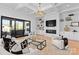 Open-concept living room with fireplace, built-ins, and sliding glass doors to outdoor balcony at 405 Sugar Maple Ln # 41, Weddington, NC 28104