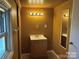 Bathroom featuring a single sink vanity, neutral color walls, and vanity lighting at 421 E Cemetary St, Salisbury, NC 28144