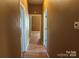 Hallway with wood-look floors offers sightlines to various rooms within the home at 421 E Cemetary St, Salisbury, NC 28144