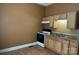 Kitchen area features double basin sink, stove, and wood cabinets at 421 E Cemetary St, Salisbury, NC 28144
