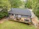 Aerial view of large deck with outdoor kitchen and entertaining area, overlooking the home's expansive yard at 4517 Lake Shore N Rd, Denver, NC 28037