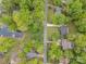 Stunning aerial view of property showcasing lush trees, a road, a lake, and neighborhood homes at 4517 Lake Shore N Rd, Denver, NC 28037
