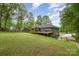 Sprawling backyard with expansive deck, swing set, and lush green lawn, perfect for outdoor enjoyment at 4517 Lake Shore N Rd, Denver, NC 28037