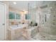 Luxurious bathroom featuring a soaking tub and a separate glass-enclosed shower with multiple shower heads at 4517 Lake Shore N Rd, Denver, NC 28037