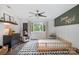 Bright bedroom with modern decor, including an accent wall and geometric rug and a view to the outdoors at 4517 Lake Shore N Rd, Denver, NC 28037