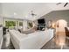 Bright living room featuring a cozy fireplace, vaulted ceiling, and large windows at 4517 Lake Shore N Rd, Denver, NC 28037