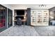 Modern office space featuring a built-in bookcase, sleek desk, and a door to the outdoors at 4517 Lake Shore N Rd, Denver, NC 28037