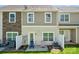 Townhome exterior with a small patio and fenced yard at 4648 Craigmoss Ln, Charlotte, NC 28278