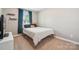 Cozy bedroom with a large window, neutral walls, and plush carpeting at 4648 Craigmoss Ln, Charlotte, NC 28278