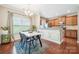 Charming dining area with modern table, stylish chairs, and natural light pouring through the window at 4648 Craigmoss Ln, Charlotte, NC 28278