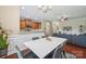 Open dining area with white marble table, adjacent to a kitchen with wood cabinets and stainless steel appliances at 4648 Craigmoss Ln, Charlotte, NC 28278