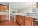 Kitchen featuring wood floors and cabinets, granite countertops, and breakfast bar at 4648 Craigmoss Ln, Charlotte, NC 28278