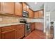 Kitchen featuring wood floors and cabinets with stainless steel appliances and granite countertops at 4648 Craigmoss Ln, Charlotte, NC 28278