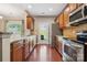 Well-equipped kitchen featuring stainless steel appliances, wooden cabinets and floors at 4648 Craigmoss Ln, Charlotte, NC 28278