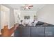 Cozy living room with a large sectional sofa, hardwood floors, and open layout at 4648 Craigmoss Ln, Charlotte, NC 28278