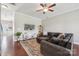 Cozy living room with plush sofa, ceiling fan, decorative rug, and a mounted TV for relaxing evenings at 4648 Craigmoss Ln, Charlotte, NC 28278