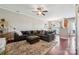 Spacious living room with a ceiling fan, hardwood floors, and open layout at 4648 Craigmoss Ln, Charlotte, NC 28278