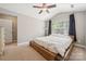 Spacious main bedroom with a platform bed, vaulted ceiling, and a large window for ample natural light at 4648 Craigmoss Ln, Charlotte, NC 28278