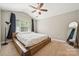 Bright main bedroom with a platform bed, vaulted ceiling, and natural light from large window at 4648 Craigmoss Ln, Charlotte, NC 28278