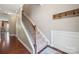 Staircase with hardwood floors and wrought iron railing at 4648 Craigmoss Ln, Charlotte, NC 28278