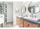 A bathroom featuring double sinks, wooden cabinetry, a large vanity, and a glass shower at 503 Bridgestone Ct, Gastonia, NC 28056