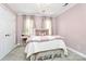 A bedroom painted pink featuring a full sized bed, chandelier, and crown molding at 503 Bridgestone Ct, Gastonia, NC 28056