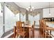 Bright breakfast nook with many windows, wooden table and chairs and lovely hardwood floors at 503 Bridgestone Ct, Gastonia, NC 28056
