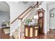 Foyer featuring a staircase, hardwood floors, and decorative furniture, creating a welcoming entrance at 503 Bridgestone Ct, Gastonia, NC 28056
