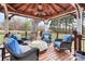 Covered gazebo with comfortable seating, a ceiling fan, and views of the backyard and trees at 503 Bridgestone Ct, Gastonia, NC 28056