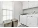 Laundry room featuring front loading washer and dryer with cabinets above at 503 Bridgestone Ct, Gastonia, NC 28056
