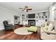 This living room boasts hardwood floors, a ceiling fan, fireplace, and custom built-ins at 503 Bridgestone Ct, Gastonia, NC 28056