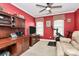 Inviting home office featuring custom built-ins, a ceiling fan, a large screen tv, and exercise bike at 503 Bridgestone Ct, Gastonia, NC 28056