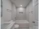 Bathroom with a tub shower, white tiled walls, and a modern vanity at 511 Hasty St, Marshville, NC 28103