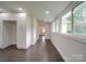 Hallway with natural light, leading to an adjacent room with extra storage at 511 Hasty St, Marshville, NC 28103