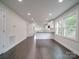 Bright, open-concept living space with hardwood floors and a breakfast bar leading to the kitchen at 511 Hasty St, Marshville, NC 28103