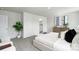 Bright bedroom with white walls, large bed, and view into a bathroom at 5232 Reedy Ridge Rd, Charlotte, NC 28215
