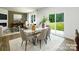 Bright dining room with a stylish table, modern chairs, and a view of the backyard at 5232 Reedy Ridge Rd, Charlotte, NC 28215