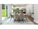 Elegant dining area with a modern table, seating for eight, and sliding glass doors at 5232 Reedy Ridge Rd, Charlotte, NC 28215